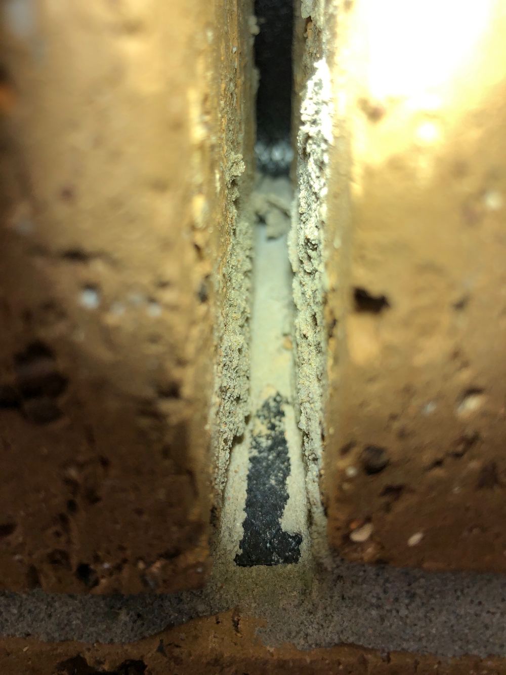 Mortar blocking weep holes along the brickwork at fixing stage, found during a fixing inspection in Truganina
