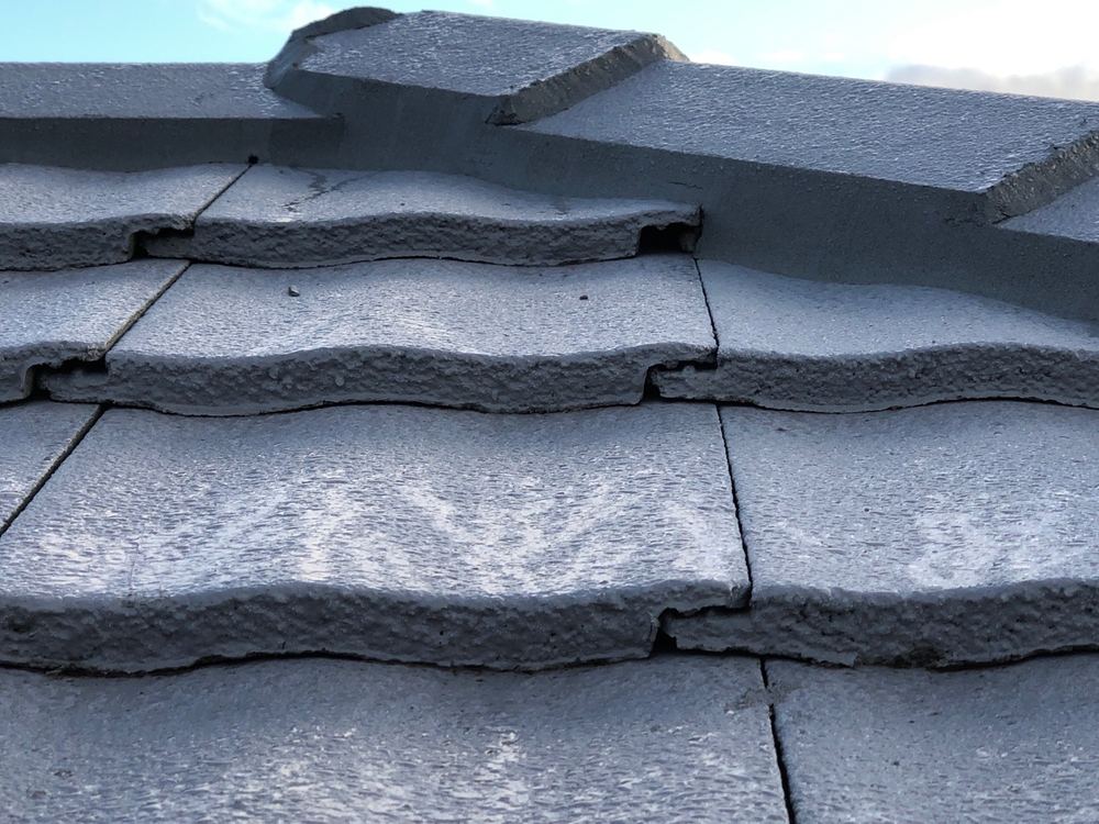 Broken tile underlap still in the roof when fixing was inspected, found during a construction stage inspection in Truganina