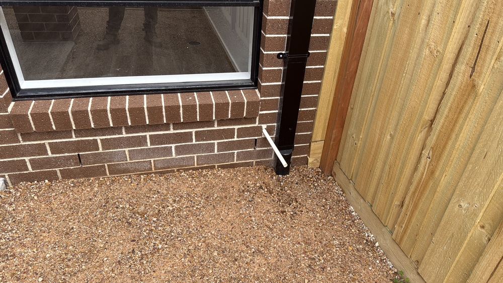 Air conditioner condensate draining straight onto the ground beside the house, Truganina
