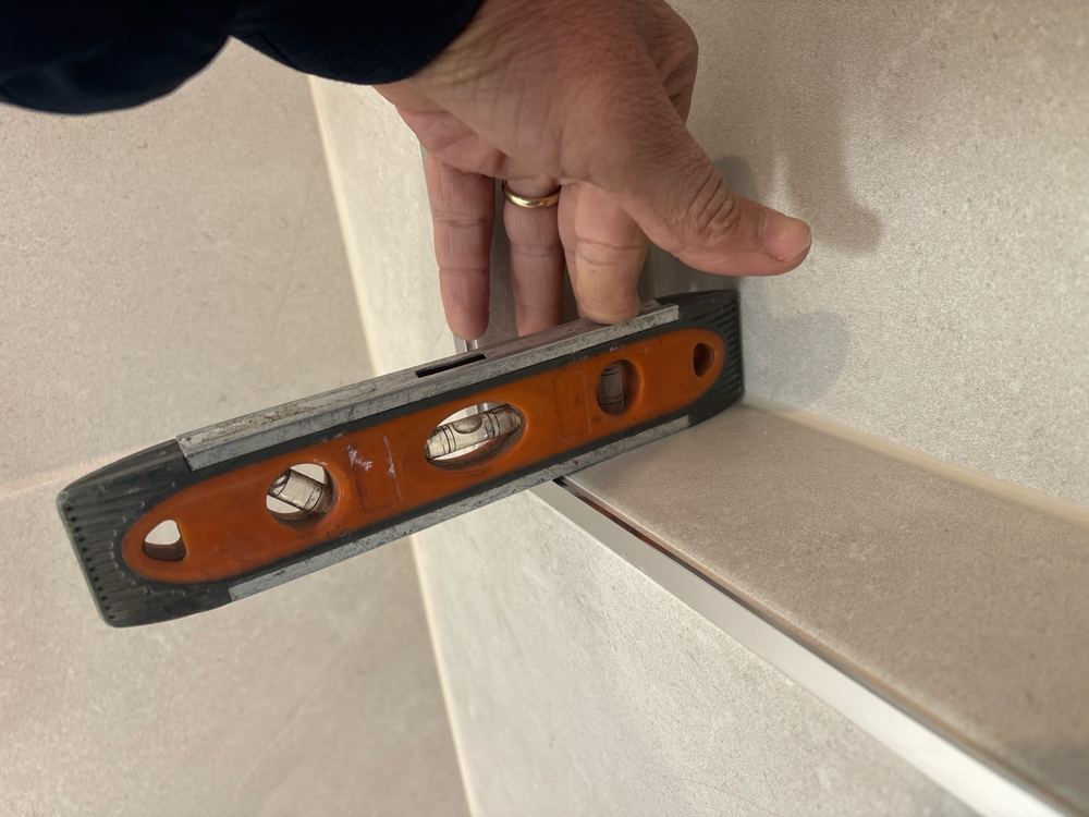 Shower niche sloping backwards, so water sits in it, found during a PCI inspection in Truganina